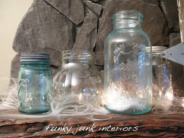 Illuminated mason jars on Christmas mantel via Funky Junk Interiors