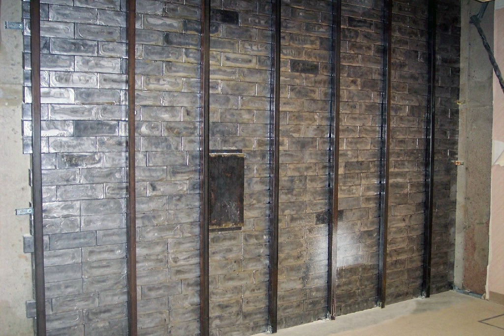 A Cracked Door Lead Brick Wall