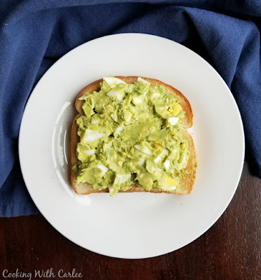One of our favorite ways to make egg salad is with avocado. It's still creamy but healthier and perfect between a couple slices of toast! avocado egg salad spread over toast