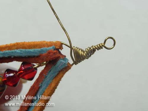 Wire wrapping from the top of the loop down to the top of the suede lace teardrop
