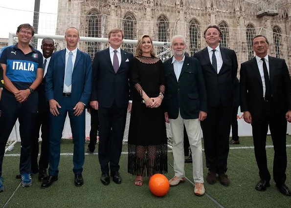 Queen Maxima and King Willem-Alexander attended a Football Clinic. Queen Maxima wore black long dress in Milan