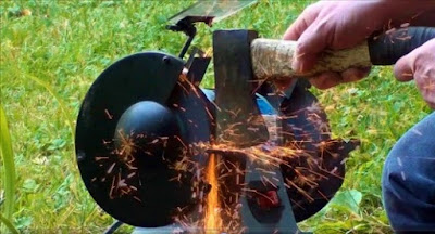 Bench grinder throwing sparks sharpening axe / hatchet