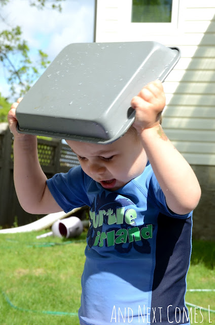 Young preschooler putting a metal pan on his head