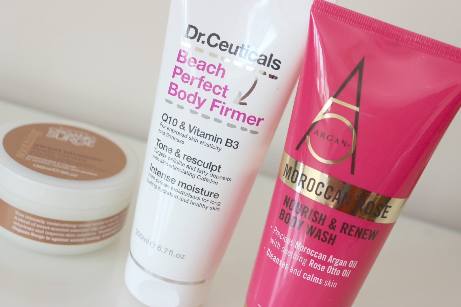 A picture of Dr. Ceuticals Beach Perfect Body Firmer, Organic Surge Soothing Sweet Blossom Body Cream and Argan+ 5 Moroccan Rose Nourish & Renew Body Wash.