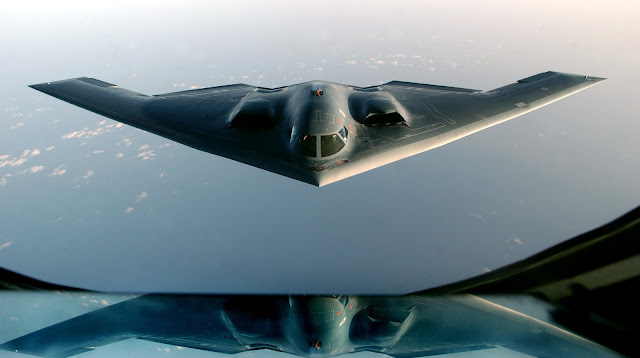 A B-2 Spirit, returning from a mission over Iraq, takes on fuel from a KC-135 Stratotanker