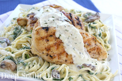 Chicken breasts, pan seared or grilled, atop a bed of pasta with a mushroom and spinach in a cheesy Mornay cream sauce.