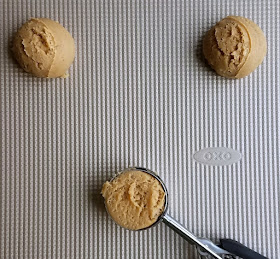 scoops of maple cinnamon cookie dough on cookie sheet getting ready to bake