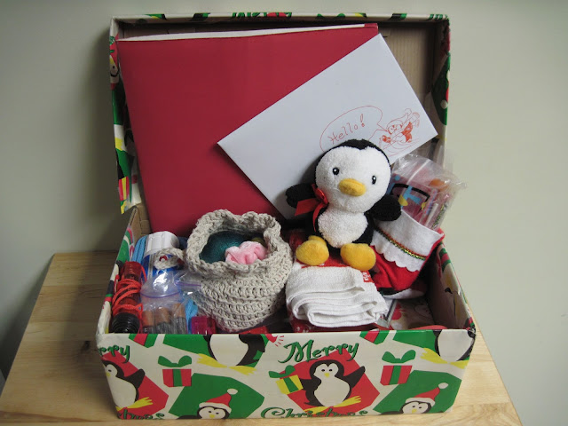 Packed OCC shoebox with penguin.