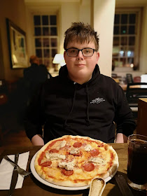 Teen boy enjoying a pizza
