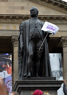 Statue of Sir Redmond Barry, holding a sign, "Equality Now"