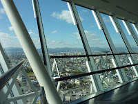 Slanted windows inside Goryokaku Tower, hakodate city ocean and mountains are visible in the background through the windows