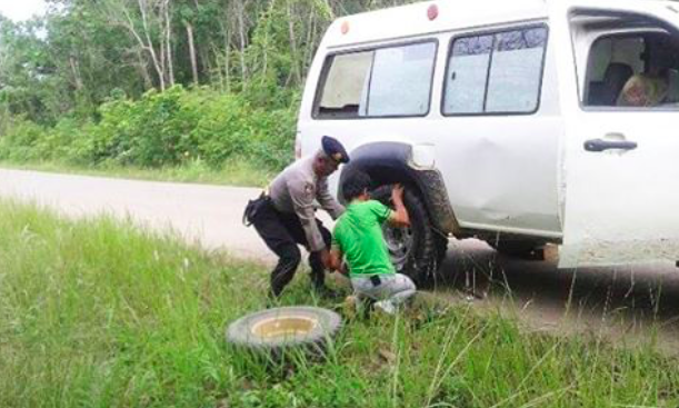 Lihat Mobil Warga Alami Pecah Ban, Kapolsek Bongan Kutai Barat Pinjamkan Ban Mobil Patroli dan Bantu Memasangnya 