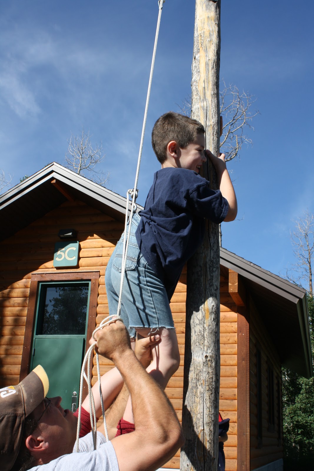 The favorite activity of all: Uncle John hanging the kids on the flag pole ...