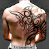 Tribal back tattoo on full back back body of a boy