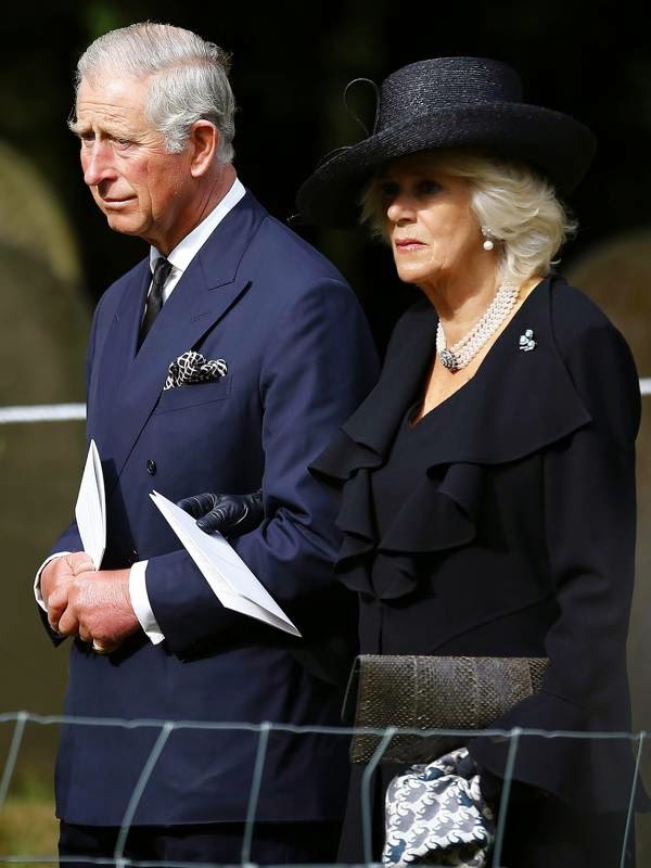 Britain's Prince Charles and Camilla Duchess of Cornwall walk to the burial site of Deborah, Dowager Duchess of Devonshire after the funeral service at St Peter's Church in Edensor, central England, 02.10.2014.
