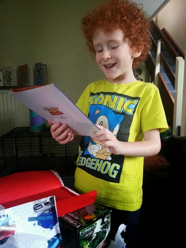 6 year old laughing at birthday card smiling