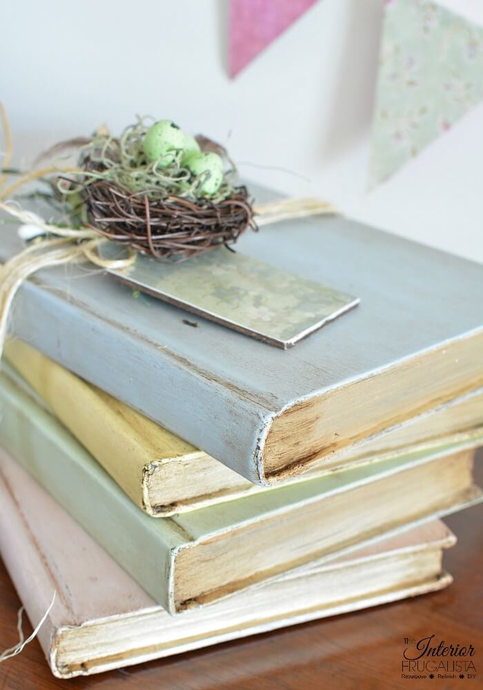 These pretty pastel painted hardcover book stacks with French Country style are an easy budget-friendly Spring decorating idea by recycling old books.