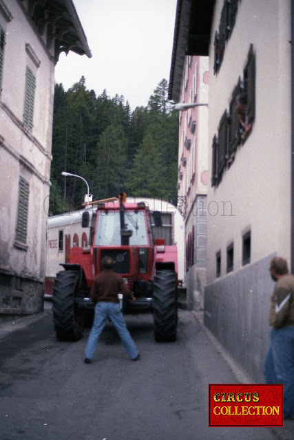 Tracteur et roulotte  du cirque Nock traversant un village grisonais 