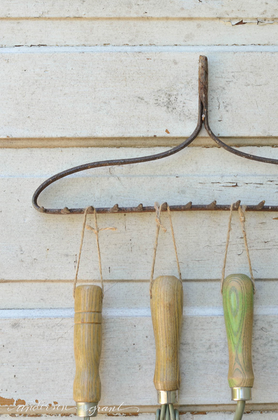 Garden Tool Organizer made from a repurposed metal rake head....a convienent and decorative way to store tools |  www.andersonandgrant.com