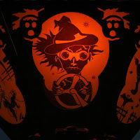 Scifi scene from The Space Witches, a orange & black silhouette Halloween paper lantern by Bindlegrim