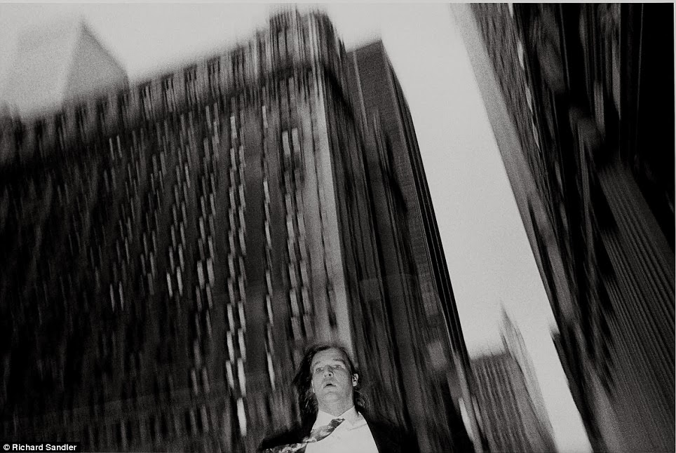 A suited man is captured on camera as he walks near broadway and wall street circa 1987 A suited man is captured on camera as he walks near broadway and wall street circa 1987