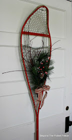 Create and easy decoration with an old snowshoe and pine boughs