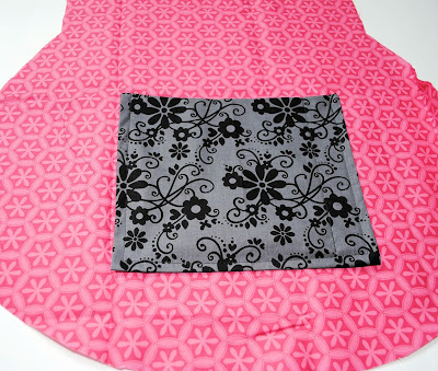 black fabric square placed on pink fabric