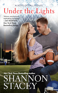 Cover description: a blond couple embrace on a football field. She's holding a football. 