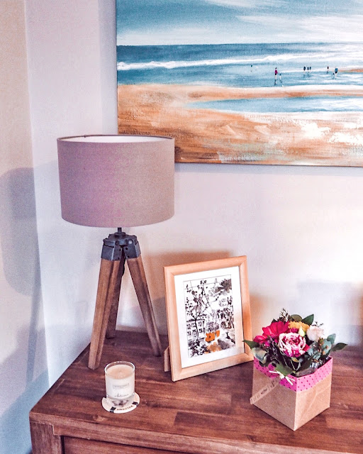 Living room sideboard with flowers and photos