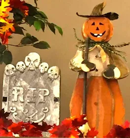 Halloween decorations witj RIP sign and scarecrow.