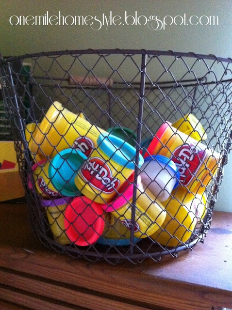 Play-doh stored in a wire basket