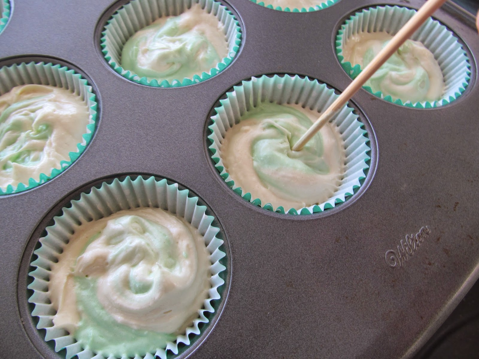 cupcake batter with green swirls