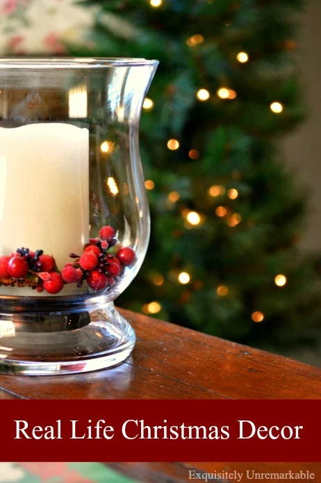 Real Life Christmas Decor text overlay on holiday candle photo