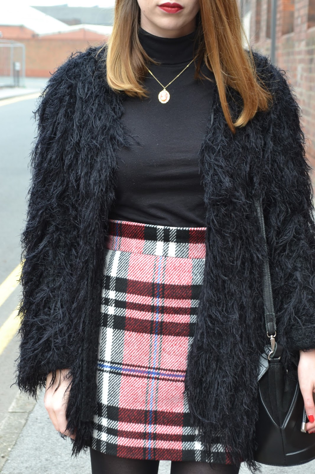 womens affordable highstreet fashion blog featuring British street style. Black polo neck. Topshop tartan skirt. Leather black buckle boots from Kurt Geiger. Black shabby jacket. Hollies closet