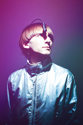 Artist Neil Harrison with an attachment connected to his head that lets him hear colors.