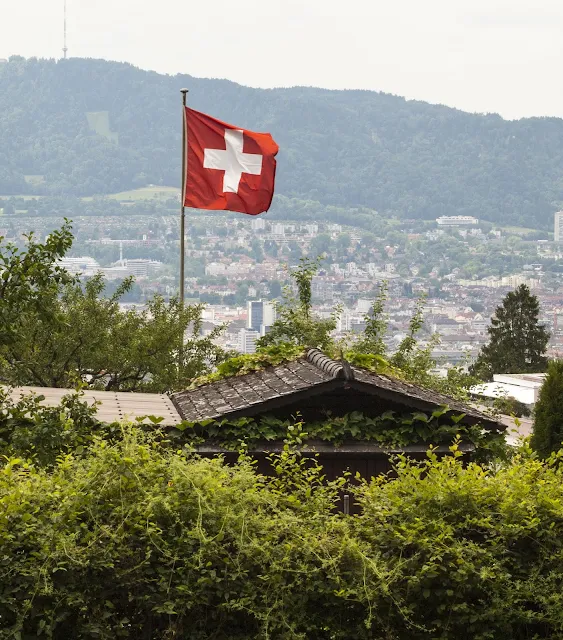 Places to Visit in Zurich in One Day with a ZVV Day Pass: Swiss Flag at a community garden