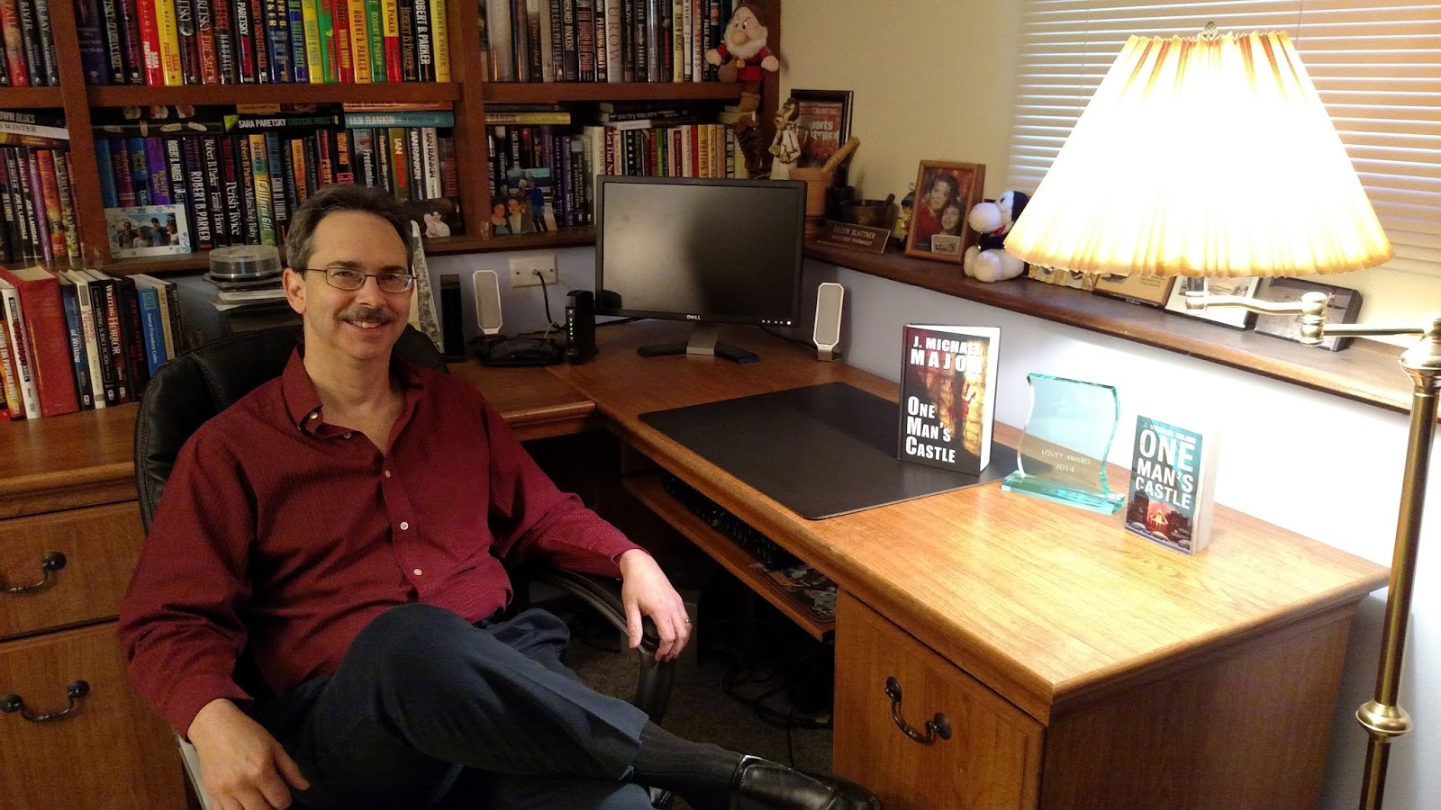 Author J. Michael Major is seated at his writing desk.