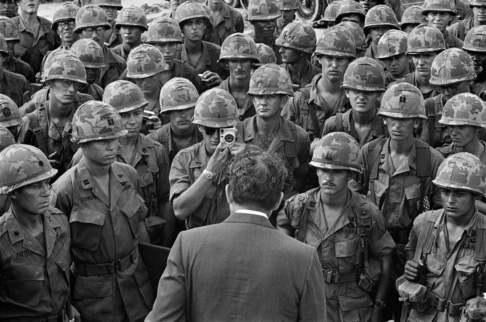 A GI gets a closeup photo as President Nixon meets with troops of the 1st Infantry Division at Di An, 12 miles northeast of Saigon, on his eighth visit to South Vietnam and his first as president, on July 30, 1969.