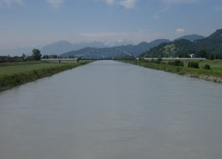 View of the distant Alps from a bridge over the river Rhein, Austria
