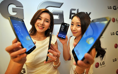 An official shows a Plastic OLED (POLED) display used in LG Electronics' curved-screen smartphone G Flex during a media event to unveil the new product at the company's headquarters in Seoul on November 5, 2013. The G Flex has a 6-inch plastic OLED display that curves inward from top and bottom. The device will hit the market in South Korea next week