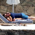 WAYNE ROONEY KISS HIS BIKINI-CLAD WIFE AS THEY SUNBATHE IN MYKONOS