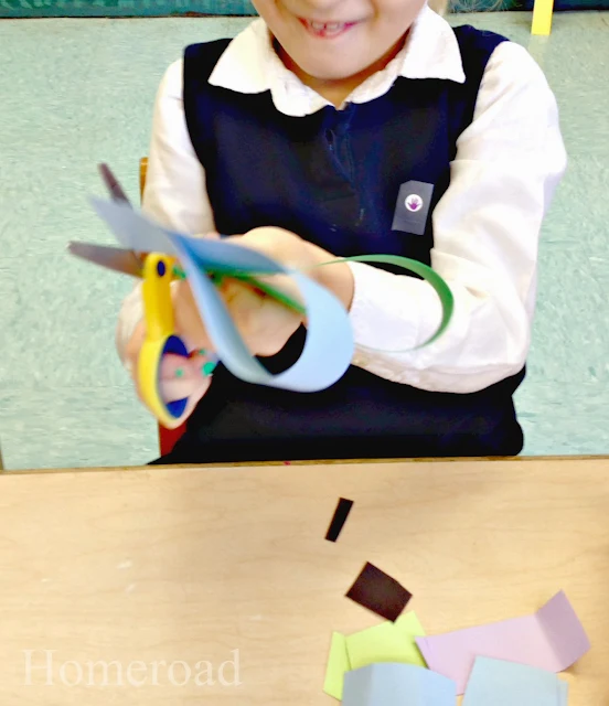 child cutting paper heart wreaths