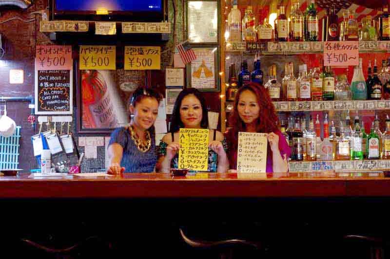 3 girls behind bar