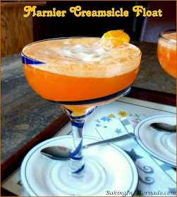 A cool refreshing summer cocktail, this Marnier Creamsicle Float is orange liqueur flavored ice cream floating in spiked orange soda. | Recipe developed by www.BakingInATornado.com | #recipe #cocktail