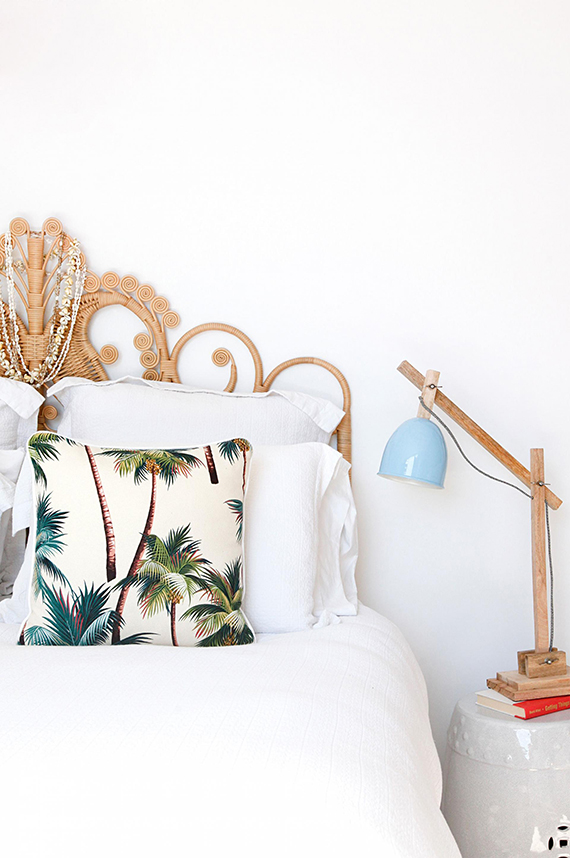 Bedroom with tropical beach vibe and bamboo bed headboard via Inside Out