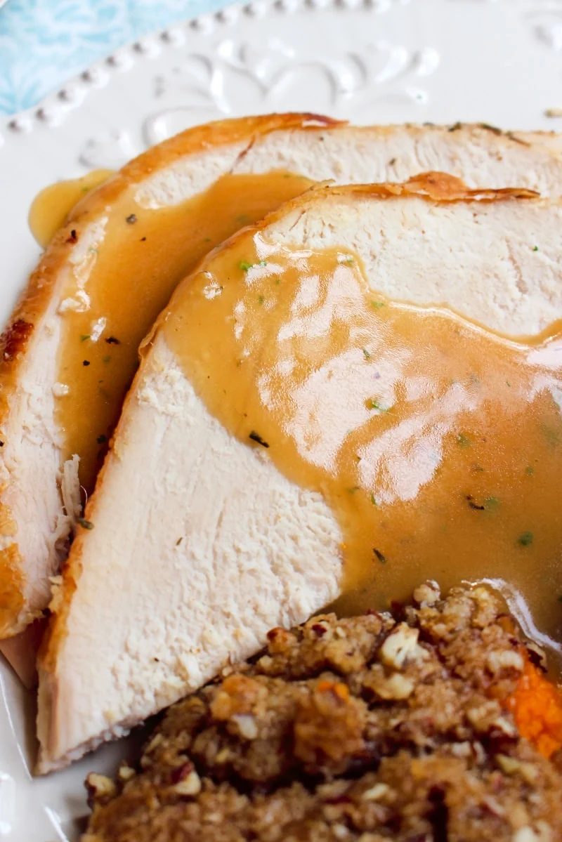 This Easy Oven Roasted Turkey recipe makes the best juicy, tender, golden brown turkey that is perfect for the holidays.  You will want to use this recipe year after year! #thanksgiving #turkey
