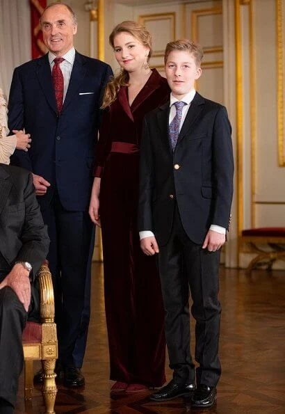 Queen Mathilde wore a floral print gown by Dries Van Noten. Crown Princess Elisabeth wore a velvet-satin jumpsuit by DVF