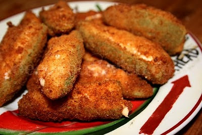 Fresh jalapeno peppers are blanched then stuffed with a bacon and cream cheese, cheddar cheese, Monterey Jack blend, dipped in buttermilk, rolled in flour and deep fried.