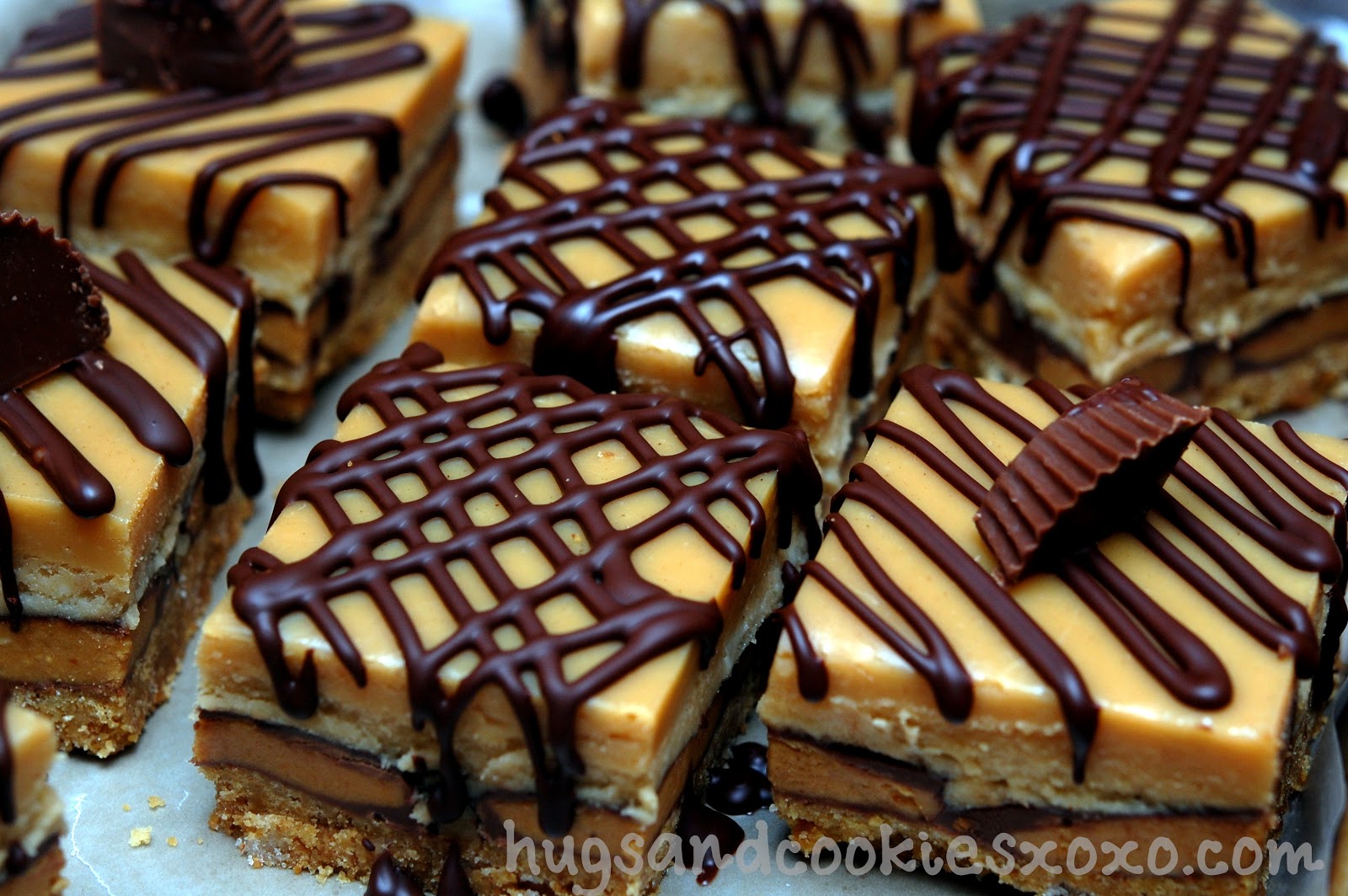 PEANUT BUTTER CHEESECAKE OVER PEANUT BUTTER CUPS SITTING ON A GRAHAM