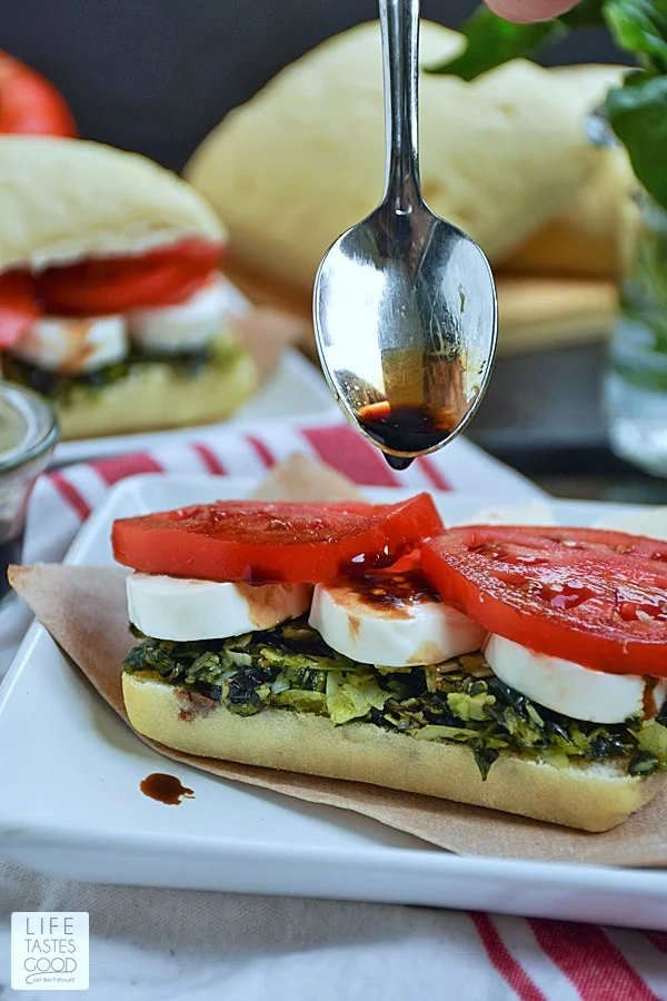Caprese Sandwich | by Life Tastes Good is a simple recipe that is big on flavor! The softest, most delicious ciabatta roll topped with fresh basil pesto, tomatoes, and creamy mozzarella cheese all drizzled with balsamic vinegar just might be my new favorite sandwich! My mouth is watering just thinking about it! #LTGRecipes